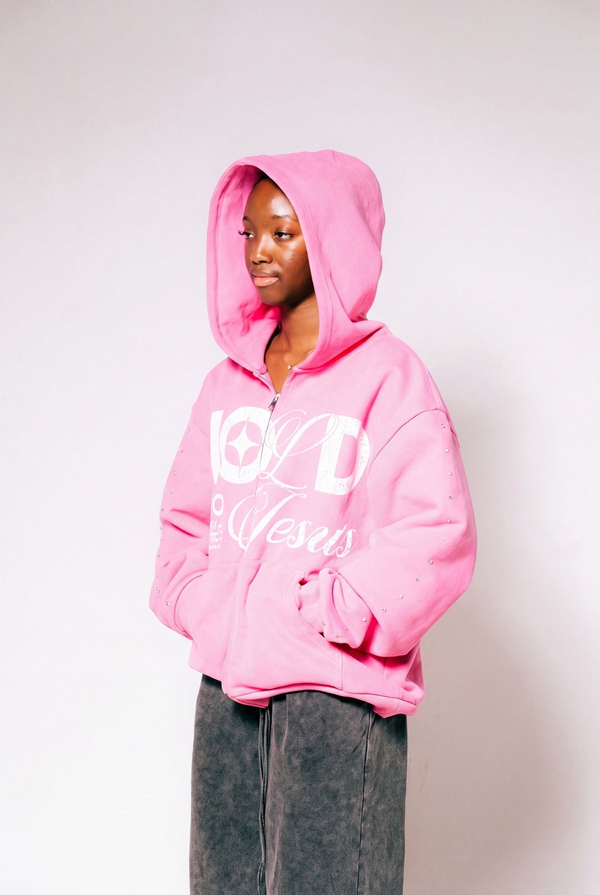 Hold On To Jesus Zip-Up Hoodie in pink, second model with hood up