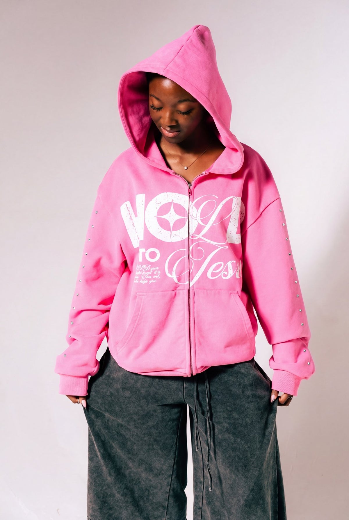 Hold On To Jesus Zip-Up Hoodie in pink, second model, hands in pockets